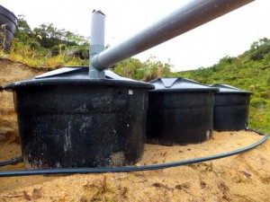 rainwater collection tanks behind toilets